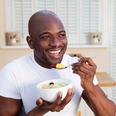 Man eating a salad, representing best foods for oral health