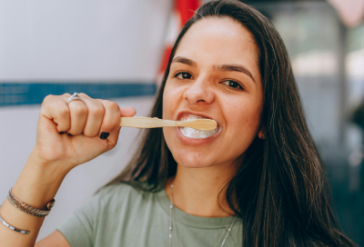 Woman brushing her teeth, representing how to brush teeth properly