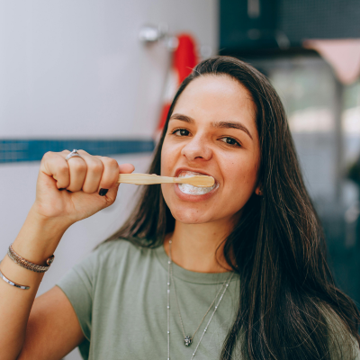 Woman brushing her teeth, representing how to brush teeth properly