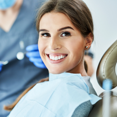 Woman smiling while at the dentist, representing smile club dental membership program