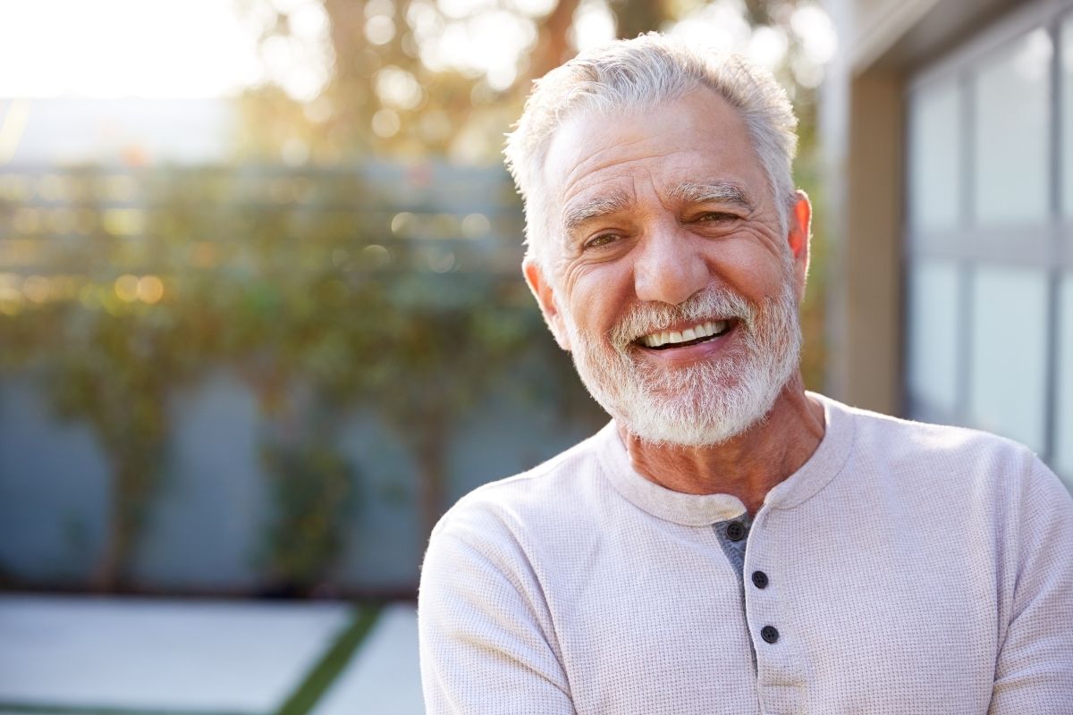 Same-day-denture-process-north-carolina Smiling senior hispanic man outdoors enjoying life with custom replacement dentures in north carolina