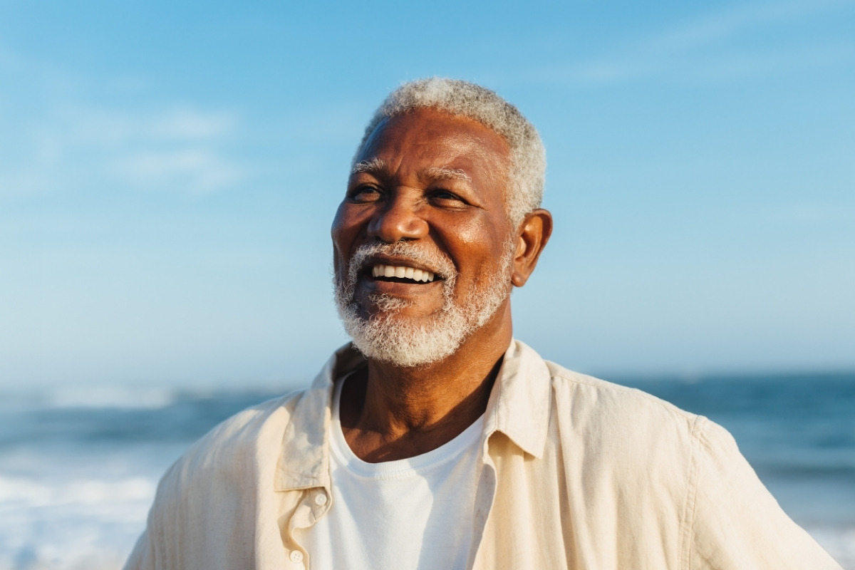 Happy senior patient smiling confidently after restorative dentistry treatment.