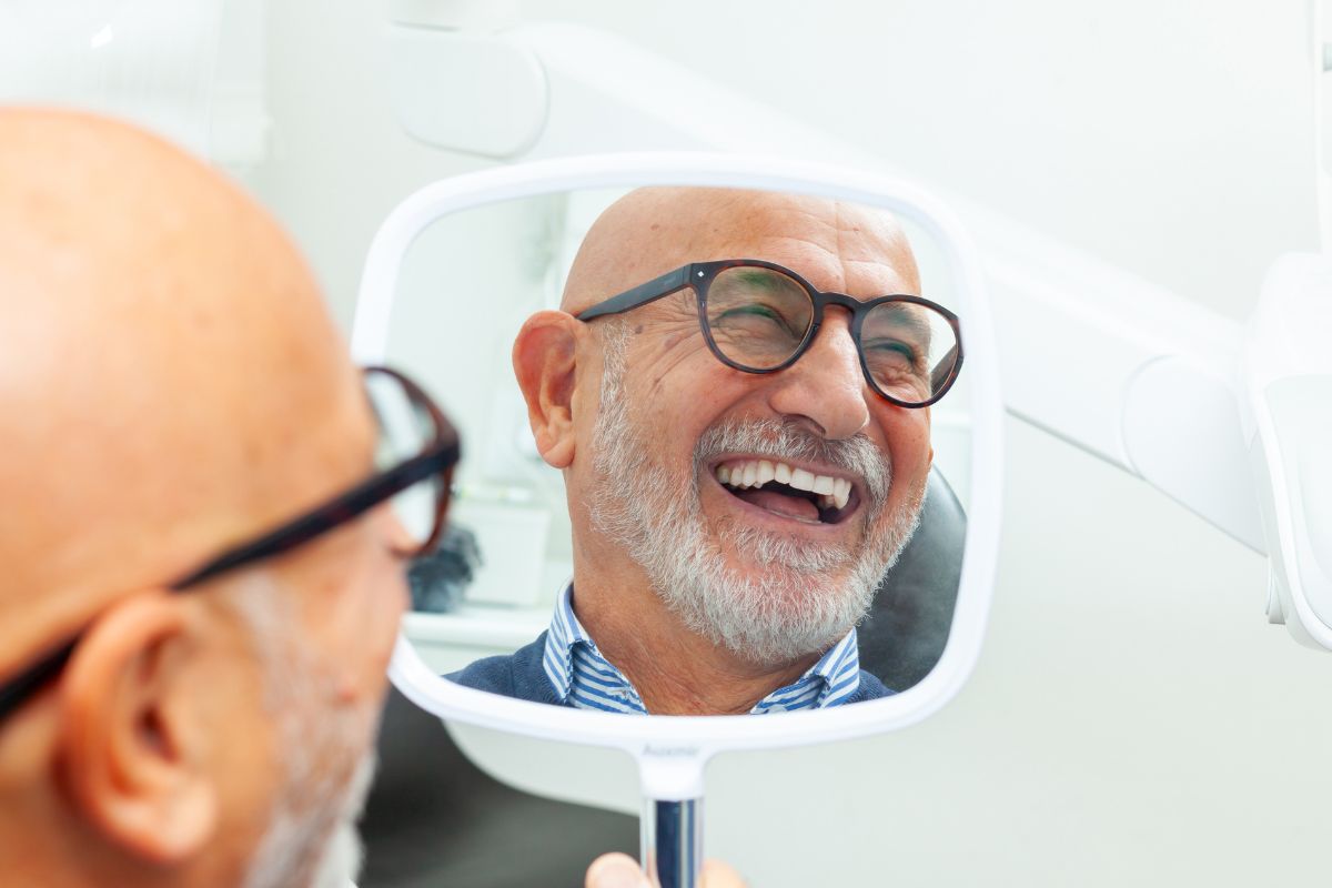 Top-rated-dental-implant-specialist-eastern-north-carolina Patient reviewing dental implant results at the dental care center serving zebulon, wake forest, fayetteville, greenville, smithfield, and wilson, north carolina.