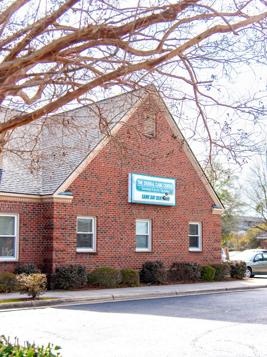 The-dental-care-center-fayetteville-office-exteral The dental care center fayetteville nc office exterior brick building with signage for general and family dentistry