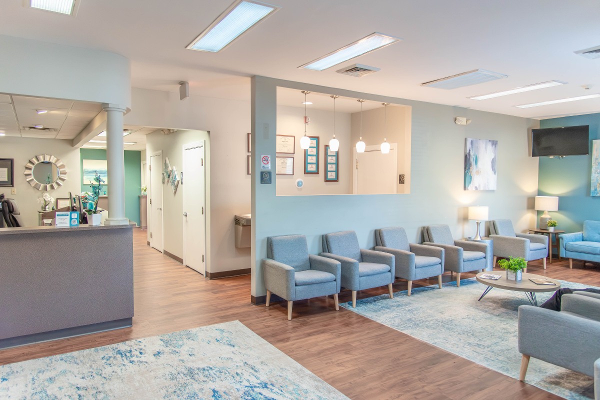 The-dental-care-center-fayetteville-office-lobby Dental office lobby in fayetteville nc with reception desk and comfortable seating for family dentistry patients