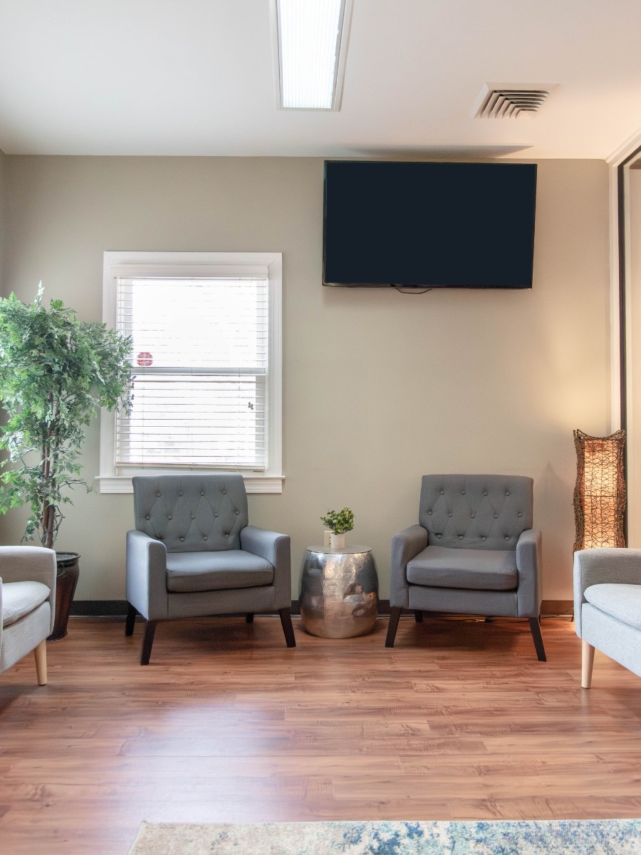 The-dental-care-center-fayetteville-office-waiting-room Bright dental waiting room in fayetteville nc with chairs and natural light at family dentistry office
