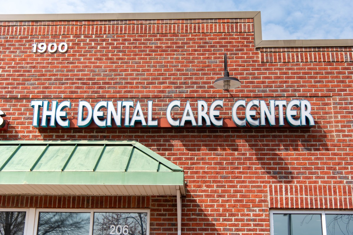 The-dental-care-center-wake-forest-office-exterior-sign The dental care center sign on building exterior in wake forest nc general family dentistry office