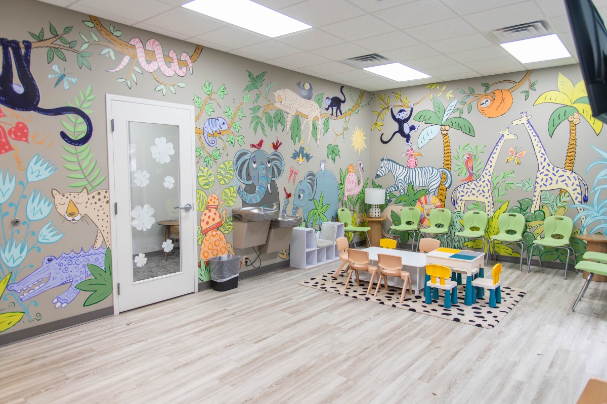 The-dental-care-center-wilson-office-kids-mural Children’s play area in wilson nc dental office with jungle mural and activity table for pediatric patients