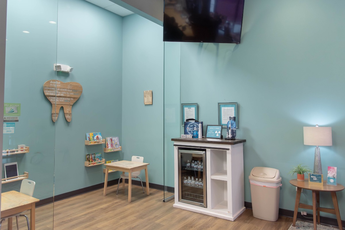 The-dental-care-center-zebulon-office-kids-area Children’s dental play area in zebulon nc with books and seating for pediatric patients